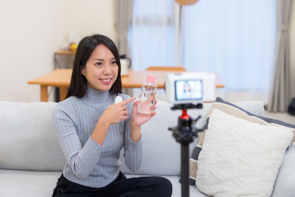 網紅對著鏡頭進行產品介紹與拍攝，象徵網紅行銷、部落客開箱與內容變現合作。